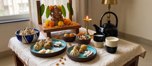 A sustainable Ganesh Chaturthi setup with reusable Black Carrot dinner set, serving bowl, katoris, and kulhad kettle