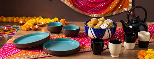 A festive Navratri table set with a Black Carrot brown and blue dinner set, serving bowl, and kulhad set